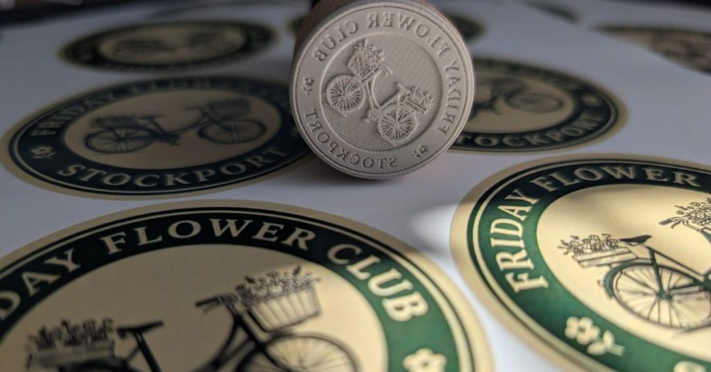 Stickers and stamp produced using an AI generated logo